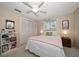Inviting bedroom with white bedding, closet storage, and natural light from the window at 1431 Normandy Ln, Palm Harbor, FL 34683