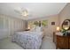 Bedroom featuring a ceiling fan, window with blinds, and closet at 1431 Normandy Ln, Palm Harbor, FL 34683