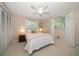 Cozy bedroom with white bedding, bedside tables, and natural light from the window at 1431 Normandy Ln, Palm Harbor, FL 34683
