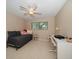 Neutral bedroom featuring a daybed, desk, and natural light from the window at 1431 Normandy Ln, Palm Harbor, FL 34683