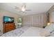 Bedroom featuring a ceiling fan, dresser and multiple closets at 1431 Normandy Ln, Palm Harbor, FL 34683