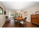 Dining room with a wood table, chandelier, and sliding doors to the outdoor patio at 1431 Normandy Ln, Palm Harbor, FL 34683