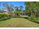 Landscaped front yard featuring lush shrubs and a well-maintained lawn at 1431 Normandy Ln, Palm Harbor, FL 34683