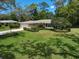 Well-manicured lawn and garden surrounding this charming single Gathering home at 1431 Normandy Ln, Palm Harbor, FL 34683