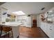 Bright kitchen featuring white cabinetry, wood floors, and a large skylight providing ample natural light at 1431 Normandy Ln, Palm Harbor, FL 34683