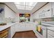 Clean kitchen featuring white appliances, ample counter space, and a bright window at 1431 Normandy Ln, Palm Harbor, FL 34683