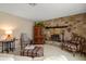 Living room showcasing a stone fireplace, classic furniture, and warm, inviting decor at 1431 Normandy Ln, Palm Harbor, FL 34683