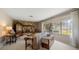 Cozy living room featuring a stone fireplace, bright windows, and comfortable seating at 1431 Normandy Ln, Palm Harbor, FL 34683