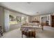 Bright living room with large windows, neutral decor, and a view of the landscaped front yard at 1431 Normandy Ln, Palm Harbor, FL 34683