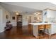 Open living space with wood floors and access to the kitchen at 1431 Normandy Ln, Palm Harbor, FL 34683