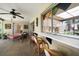 Covered patio featuring tile floor, bar seating to kitchen, and a ceiling fan for comfortable outdoor living at 1431 Normandy Ln, Palm Harbor, FL 34683
