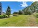 Expansive backyard with lush green lawn and serene pond views, offering a peaceful retreat at 14421 Swiss Bridge Dr, Lithia, FL 33547