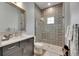 Modern bathroom offers a sleek vanity and a beautifully tiled walk-in shower at 14421 Swiss Bridge Dr, Lithia, FL 33547