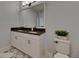 Elegant bathroom with dual sinks, dark countertops, and fixtures with bright lighting at 14421 Swiss Bridge Dr, Lithia, FL 33547