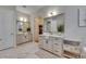 Bright and open bathroom with double vanity, marble tile, and adjoining walk-in closet at 14421 Swiss Bridge Dr, Lithia, FL 33547