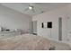 Charming bedroom boasts soft pink walls, ceiling fan, tv, and a plush bed, creating a relaxing and inviting atmosphere at 14421 Swiss Bridge Dr, Lithia, FL 33547