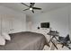 This bedroom features light grey walls, a ceiling fan, closet, dresser, and a full bed at 14421 Swiss Bridge Dr, Lithia, FL 33547