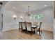 Bright dining room features modern lighting, wainscoting, and large windows bringing the outside in at 14421 Swiss Bridge Dr, Lithia, FL 33547