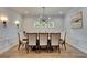 Well-lit dining room has ample seating, stylish lighting, and elegant design at 14421 Swiss Bridge Dr, Lithia, FL 33547