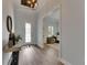 Inviting foyer with decorative front door, wood-look tile flooring, and view into the home office at 14421 Swiss Bridge Dr, Lithia, FL 33547