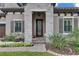 Inviting front entrance with a stone facade, decorative door, and lush landscaping at 14421 Swiss Bridge Dr, Lithia, FL 33547