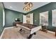 Beautifully designed game room with pool table, decorative lighting, and a clear view into the kitchen at 14421 Swiss Bridge Dr, Lithia, FL 33547
