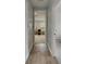 Inviting hallway showcases wood flooring, neutral paint, and seamless flow into a cozy living space and rooms at 14421 Swiss Bridge Dr, Lithia, FL 33547