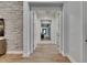 Hallway features beautiful flooring and a view into living spaces at 14421 Swiss Bridge Dr, Lithia, FL 33547