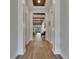 Inviting hallway featuring wood-look tile floors, decorative columns and wood plank ceiling accents at 14421 Swiss Bridge Dr, Lithia, FL 33547