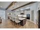 Beautiful kitchen with island seating, beamed ceiling, and open access to the living room at 14421 Swiss Bridge Dr, Lithia, FL 33547