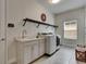 Well-lit laundry room features modern appliances, ample counter space, and stylish accents for convenient chores at 14421 Swiss Bridge Dr, Lithia, FL 33547