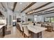 Bright open living space with a marble island, wood beams, and access to a kitchen and dining area at 14421 Swiss Bridge Dr, Lithia, FL 33547