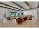Large living space featuring a comfortable sectional sofa, wood beams, and open floorplan at 14421 Swiss Bridge Dr, Lithia, FL 33547