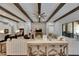 Comfortable living area features exposed wood beams, a stone accent wall, and an open floor plan at 14421 Swiss Bridge Dr, Lithia, FL 33547