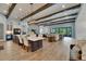 Spacious living room with wood beams, open floor plan, and marble counter seating area at 14421 Swiss Bridge Dr, Lithia, FL 33547