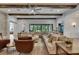 Spacious living area with an oversized sectional, wood beam ceilings, and natural light at 14421 Swiss Bridge Dr, Lithia, FL 33547