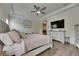 This main bedroom features a tray ceiling, ceiling fan and connects to the en suite bathroom at 14421 Swiss Bridge Dr, Lithia, FL 33547