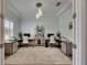 Spacious home office with custom built-ins, modern lighting, and neutral color palette at 14421 Swiss Bridge Dr, Lithia, FL 33547