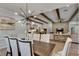 Open floor plan seamlessly connects dining to living spaces, with exposed beams and brick accent wall at 14421 Swiss Bridge Dr, Lithia, FL 33547