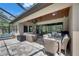 This screened patio has an outdoor kitchen, living area, wood ceiling, and dining table at 14421 Swiss Bridge Dr, Lithia, FL 33547