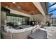 This screened patio has an outdoor kitchen, living area, wood ceiling, and dining table at 14421 Swiss Bridge Dr, Lithia, FL 33547