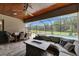 This patio features an outdoor living area, dining table, wood ceilings, and pool with screen enclosure at 14421 Swiss Bridge Dr, Lithia, FL 33547