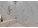 This walk-in shower features marble tile, a built-in bench, and dual shower heads at 14421 Swiss Bridge Dr, Lithia, FL 33547