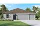 Charming single-story home with a two-car garage and lush landscaping at 1457 Brown Mallet Pl, Ruskin, FL 33570
