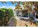 Secluded backyard showcasing a well-maintained lawn and privacy hedge, providing a tranquil outdoor setting at 1601 Fluorshire Dr, Brandon, FL 33511