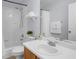 Bathroom with white tiled shower, white vanity and a large mirror at 1601 Fluorshire Dr, Brandon, FL 33511