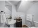 Quaint bathroom features a pedestal sink, wood floors, and coordinated fixtures at 1601 Fluorshire Dr, Brandon, FL 33511