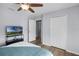 Bright bedroom offers wood floors, neutral paint, ceiling fan, and walk-in closet at 1601 Fluorshire Dr, Brandon, FL 33511