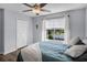 Bright bedroom offers wood floors, neutral paint, large window, and ceiling fan at 1601 Fluorshire Dr, Brandon, FL 33511