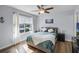 Bright bedroom features wood floors, neutral paint, and large window with neighborhood view at 1601 Fluorshire Dr, Brandon, FL 33511